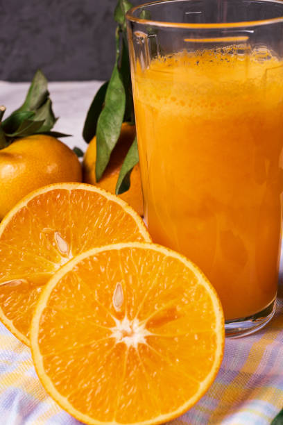 istock Orange fruit and some juice in a glass , over rustic background, closeup. 1066637746
