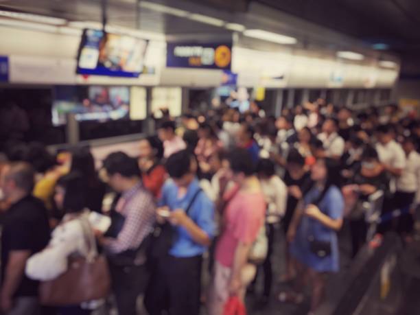 istock blurred image of Crowded station with people and passenger standing, walking and waiting for pick and choose the best public transport during rush hour in Bangkok city. 1066638228
