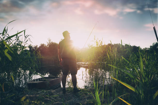 istock fisherman with fishing rod 1066640186