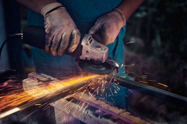 istock industrial grinding make surface of metal flat,  master in a workshop 1066641118