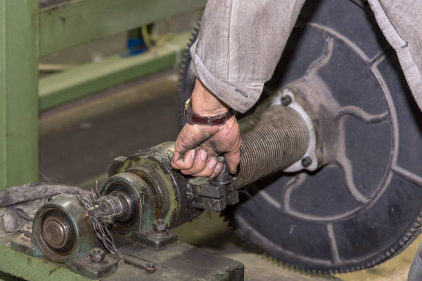 istock A mechanic repairs a machine in a factory. 1066647226