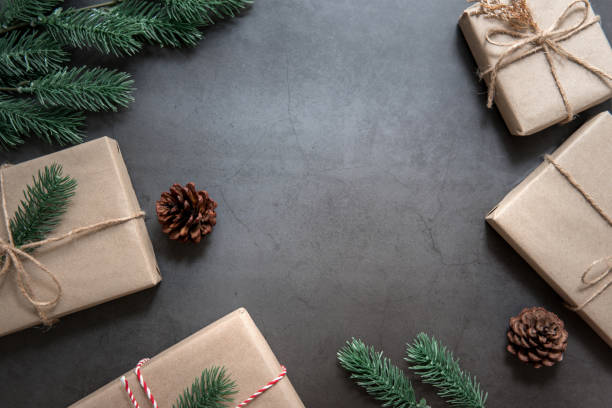 istock Christmas gift boxess pine branches on black background. Flat lay, top view 1066649976