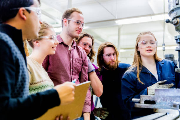 istock Group of Engineering Students Observing the Senior Student Operating a Heavy Machinery 1066650028