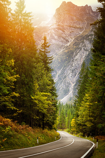 A road thru mountain pass in dolomites during autumn with beautiful colors, Italy, Europe