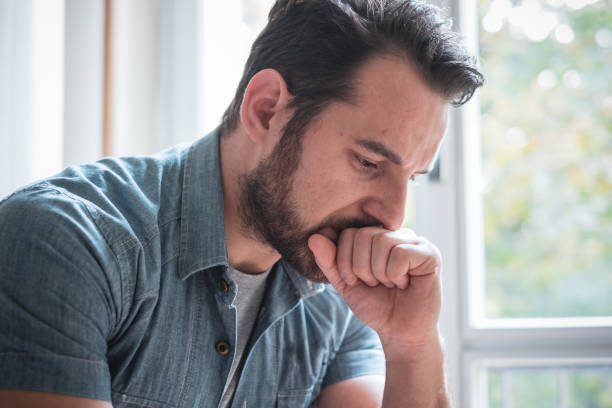 istock Worried man looking thoughtful out of window 1066651030