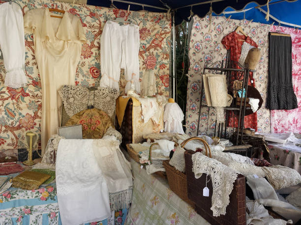 A romantic display of antique clothings and fabric in a flea market in Paris.