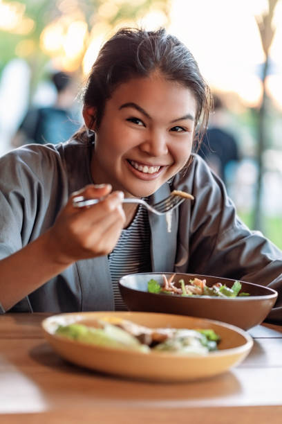 istock Asian woman having lunch 1066653288