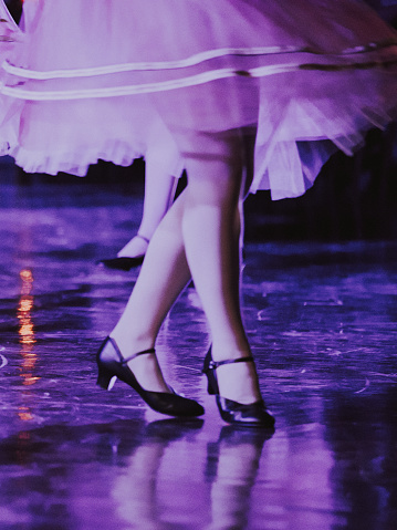 Dancing Legs Wearing Black Shoes and Dress, Purple Ambiance