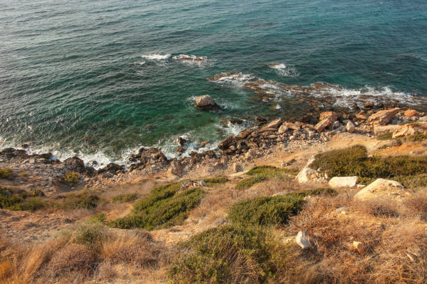 istock View from steep sea shore hill covered with grass, rocks and deep blue ocean water in background. Karpass, Northern Cyprus 1066655842