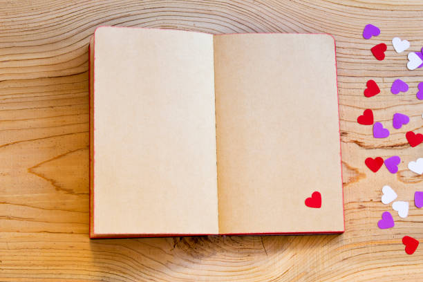 istock open notebook with red heart on wood background. 1066659792