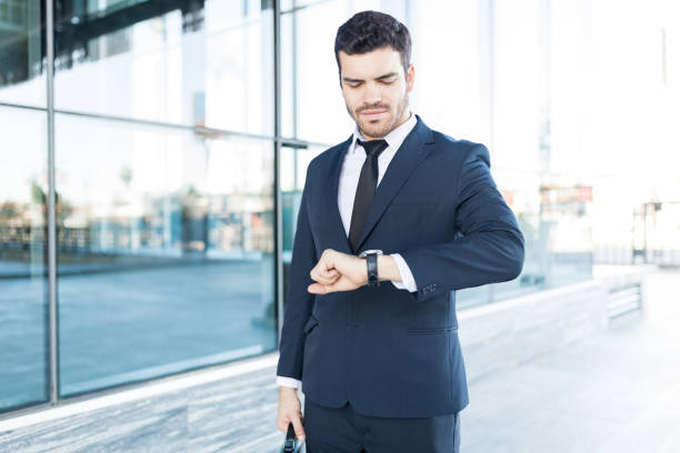 istock Young Male Executive Tracking Time On Watch 1066662132
