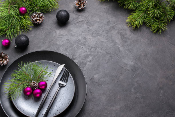 istock Christmas menu concept . Flat lay with Xmas decorations, dark plates, fork and knife set with napkin. Copy space 1066663114