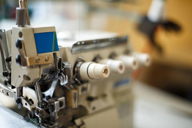 istock closeup details on sewing machine overlock. Workplace seamstress.Tailoring industry. 1066667760
