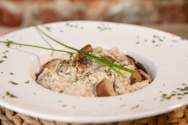 istock a close up of mushroom risotto in a white plate 1066669788