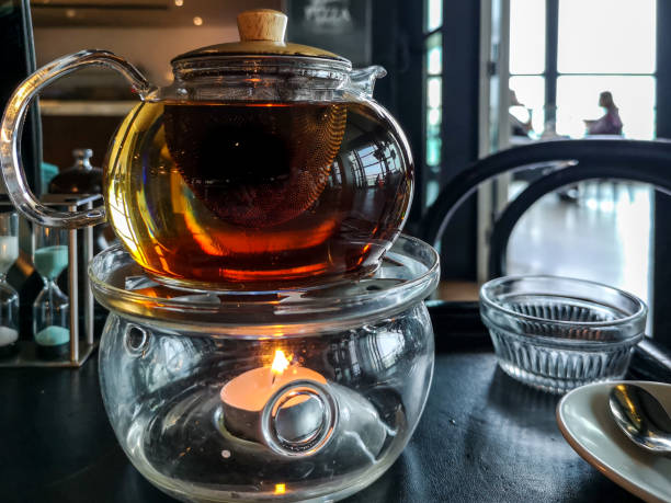 istock Tea pot above a candle with restaurant background 1066670580