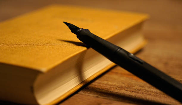 istock black pen at brown hard covered book 1066672428