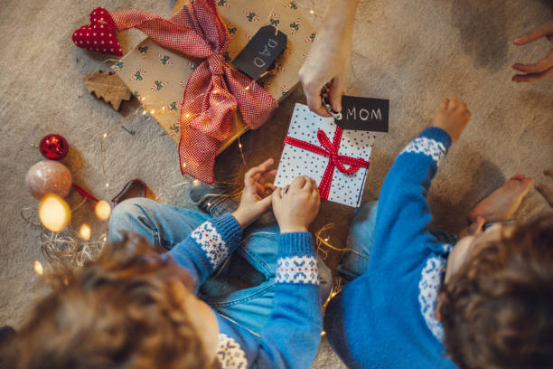 istock Kids wrapping christmas gifts 1066672756
