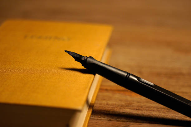 istock black pen at brown hard covered book 1066672758