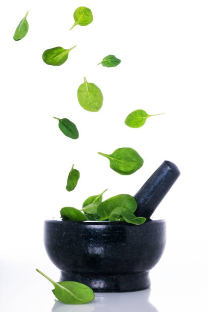 istock Food in motion, spinach leaves flying 1066672900