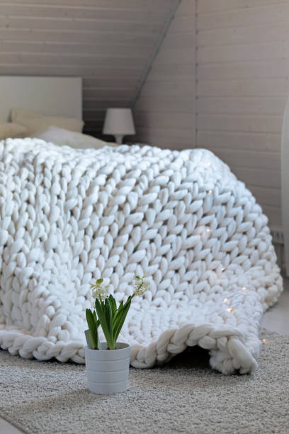 istock White scandinavian interior with knit plaid. 1066675440