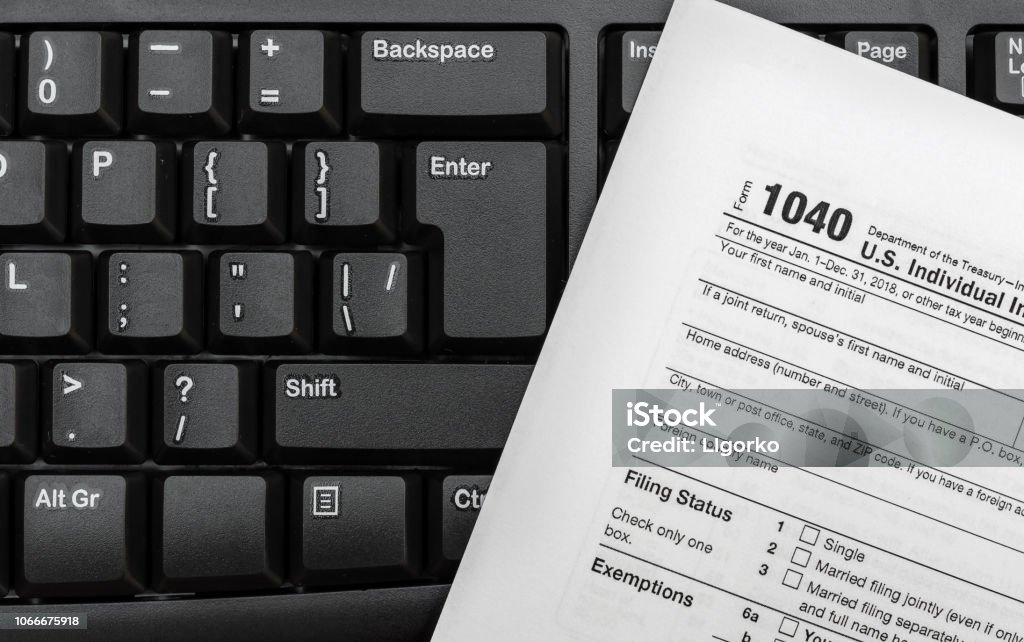 Tax form on black keyboard. Close up. Tax Form Stock Photo