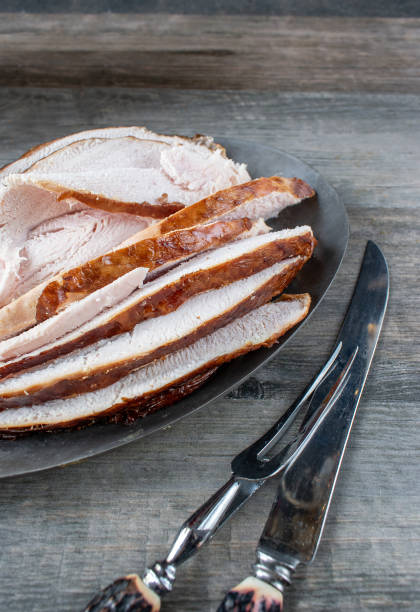 Turkey slices of white meat on platter with knife and fork top view