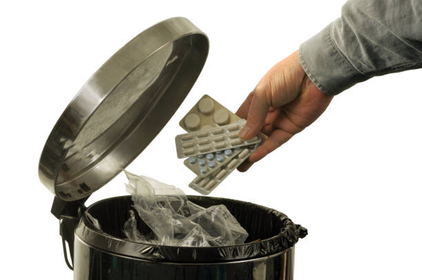istock Throwing drugs in the trash 1066684990