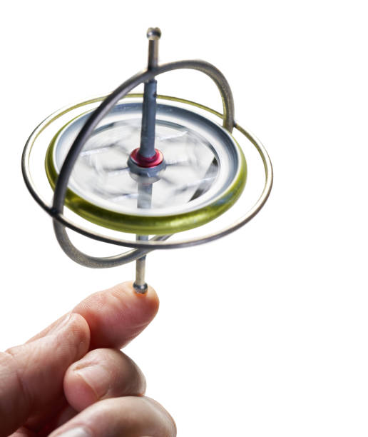 Gyroscope toy on white background that is spinning on hand finger keeping balance for spin concept