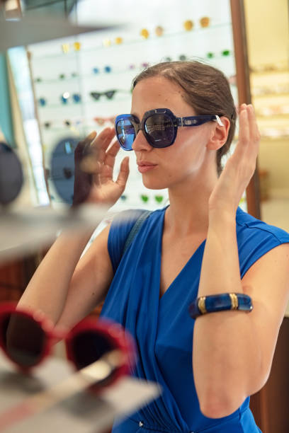 istock Woman trying on sunglasses 1066688218
