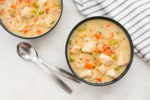 Chicken and Corn Chowder Bowls of chowder with spoons and a napkin Chowder stock pictures, royalty-free photos & images