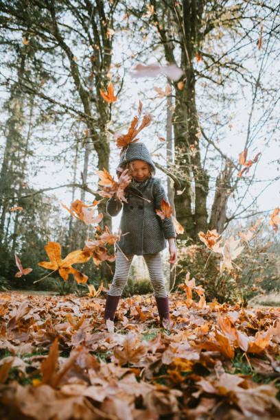 istock Children Playing In Autumn Leaves 1066693936