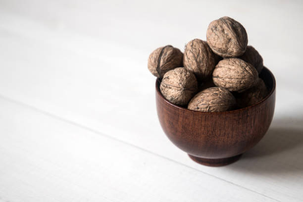 istock wallnuts in wooden bowl 1066697178