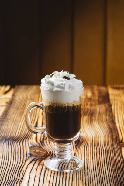 istock Irish coffee in glass on wooden table 1066697528