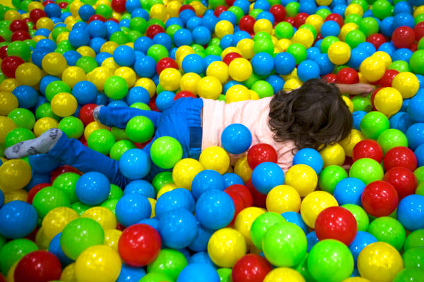 istock Cute Little boy playing at colorful plastic balls playground. 1066710170