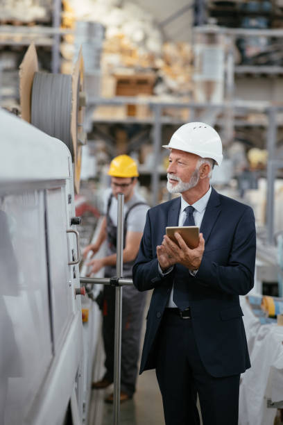 istock Senior engineer in factory controlling production line 1066710468