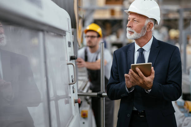 istock Senior engineer in factory controlling production line 1066711718