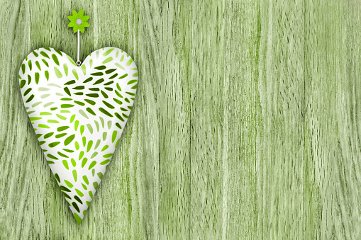 Heart and green wooden background