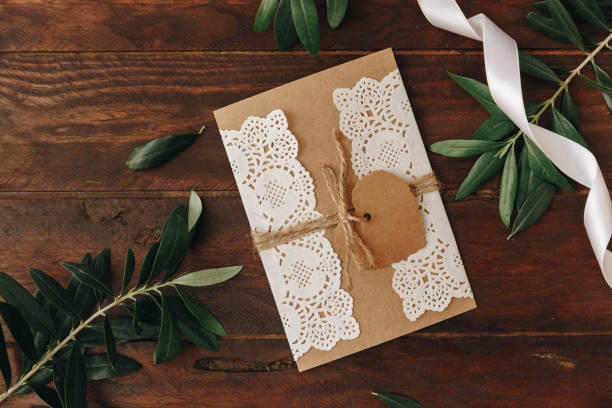 Handmade flat lay greeting card and envelope on wooden background for creative work design