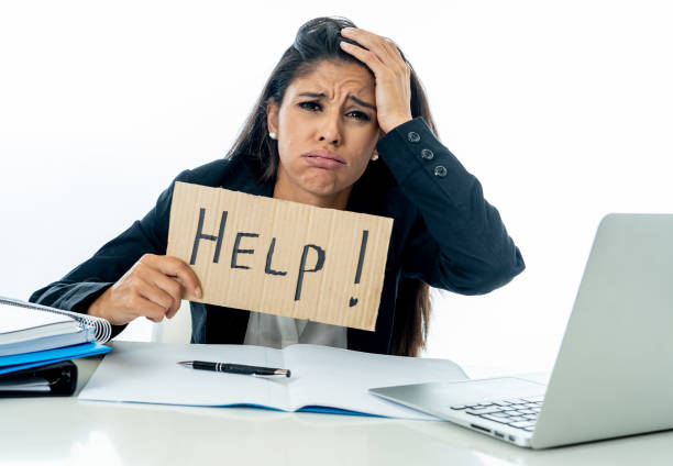 istock Young attractive businesswoman working on computer laptop suffering stress at office going crazy holding a help sign 1066724800