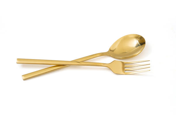 colher de ouro e garfo isolado em um fundo branco - silverware spoon isolated fork - fotografias e filmes do acervo
