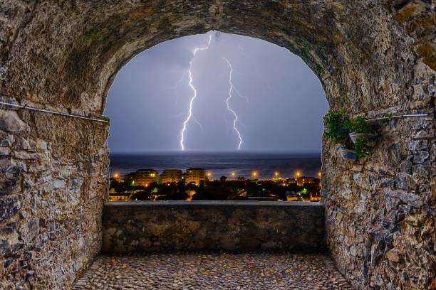 istock Rock balcony overlooking a lightning storm over the sea 1066727300