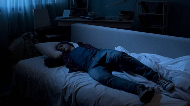 istock Young man sleeping in clothes tired after student party difficult period in life 1066730106