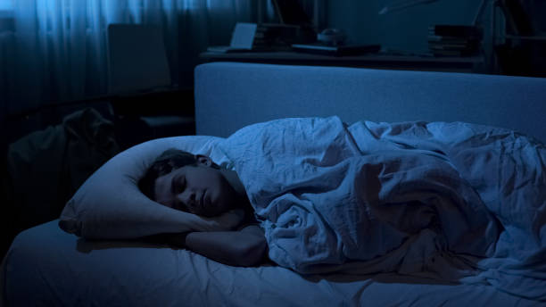 istock Nice young boy sleeping deep in his bed after hard day at university, relaxation 1066730256