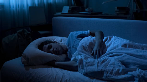istock Overworked cute male student sleeping in his bed after working day at collage 1066730272