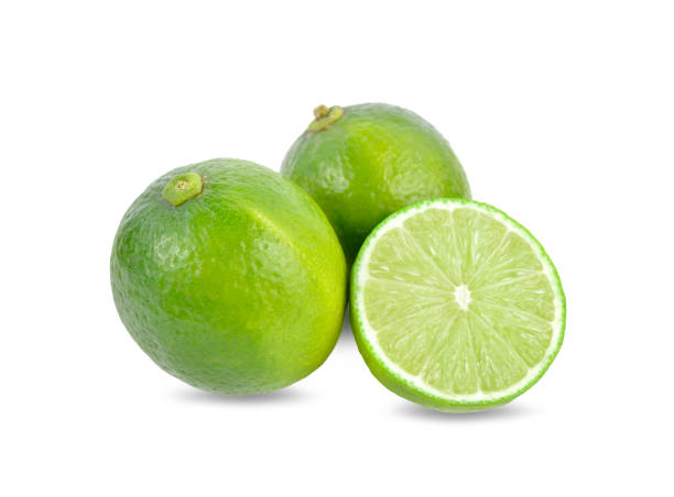 istock whole and half cut fresh lime on white background 1066734402