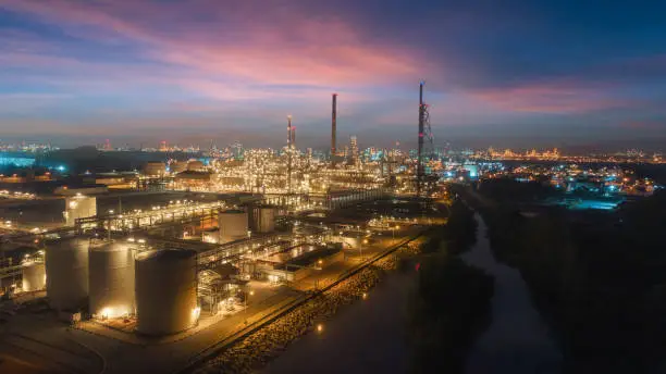 Photo of Oil refinery factory with beautiful sky at dusk for energy or gas industry or transportation background.