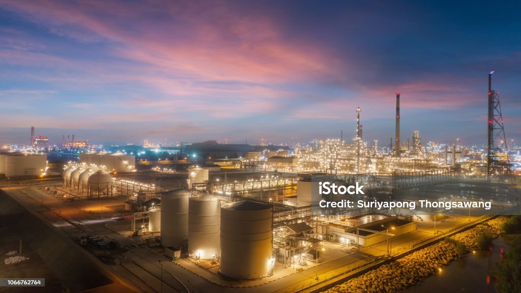 Oil refinery factory with beautiful sky at dusk for energy or gas industry or transportation background. Chemical Plant Stock Photo