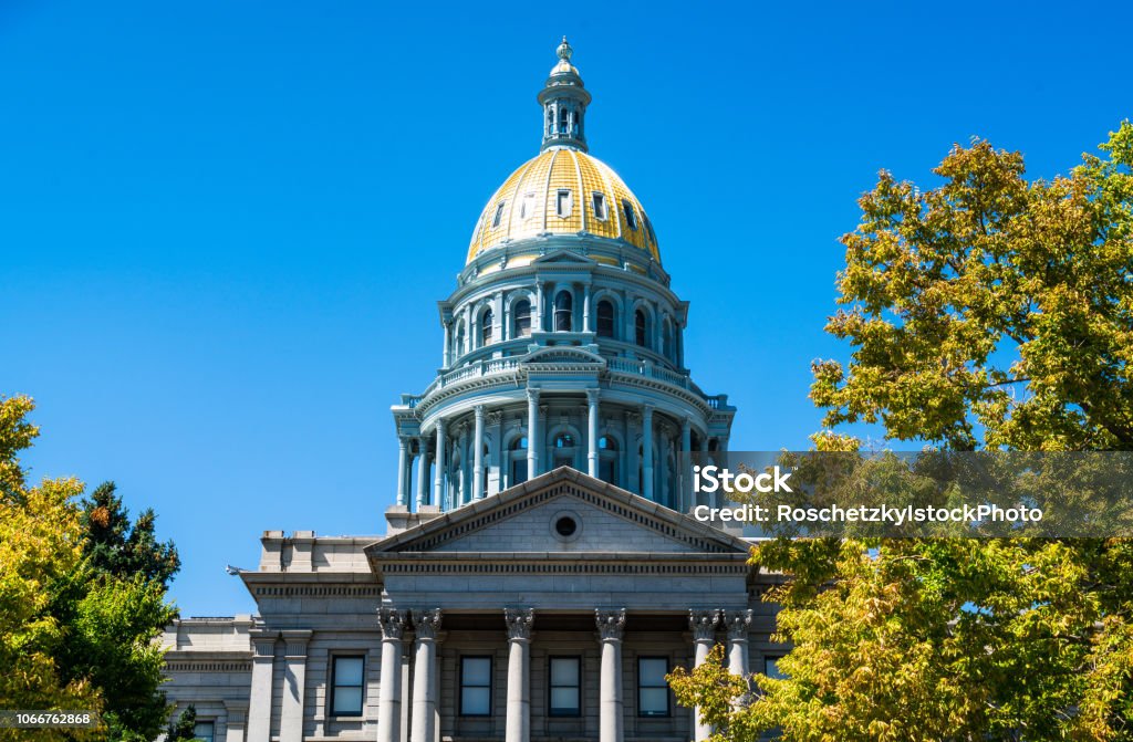 Denver , Colorado summer time walking up to the Colorado State Capital building Denver , Colorado summer time walking up to the Colorado State Capital building with green trees and clear blue sky Colorado Stock Photo