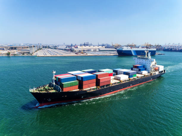 istock Container ship at sea port for logistics import  export or transportation concept background. 1066764724