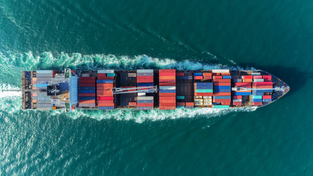 istock Aerial view Top speed with beautiful wave of container ship full load container with crane loading container for logistics import  export or transportation concept background. 1066764992